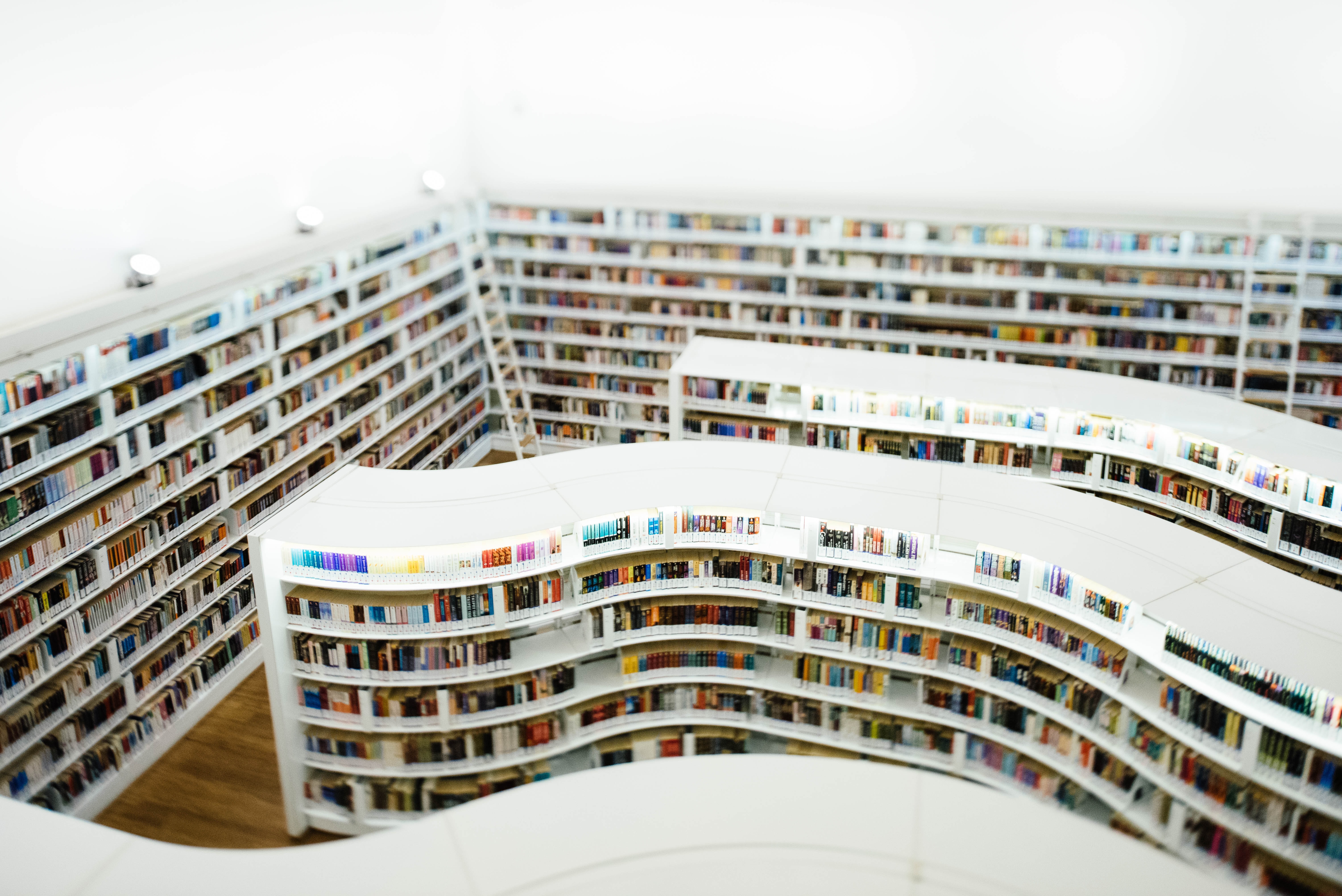 colourful books on white shelves