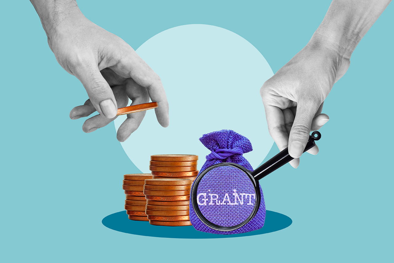 Concept of research funding with coins, magnifying glass, and hands  on blue background